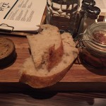 Bread with honey butter and pickled vegetables served at seating