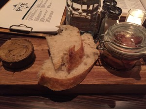 Bread with honey butter and pickled vegetables served at seating