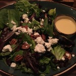Greens salad with goat cheese, blueberries and pecans