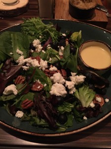 Greens salad with goat cheese, blueberries and pecans
