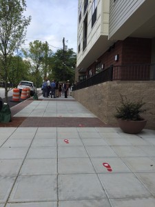 Attendees gather for "ribbon-chewing" by Cause for Paws rescue dog at The Lincoln Apartments