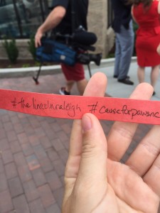 Attendees gather for "ribbon-chewing" by Cause for Paws rescue dog at The Lincoln Apartments