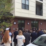 Attendees gather for "ribbon-chewing" by Cause for Paws rescue dog at The Lincoln Apartments