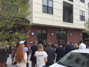Attendees gather for "ribbon-chewing" by Cause for Paws rescue dog at The Lincoln Apartments